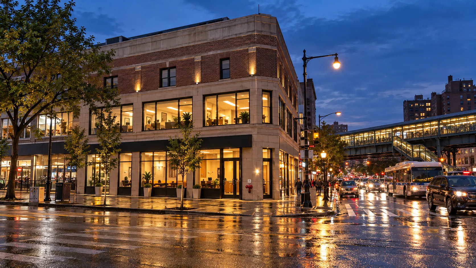 Illustrative image of a three-level corner commercial building in the Bronx at dusk, with lit second-floor offices and an elevated station nearby